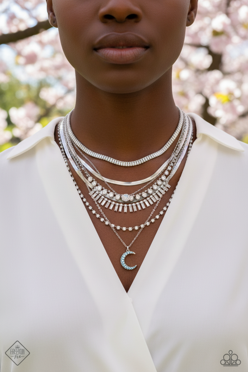 Black model wearing layered silver necklaces with spring background