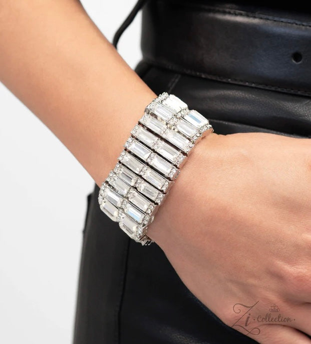 A close-up image of a person's wrist wearing a sparkling white emerald-cut gemstone bracelet from the White-Zi Collection.